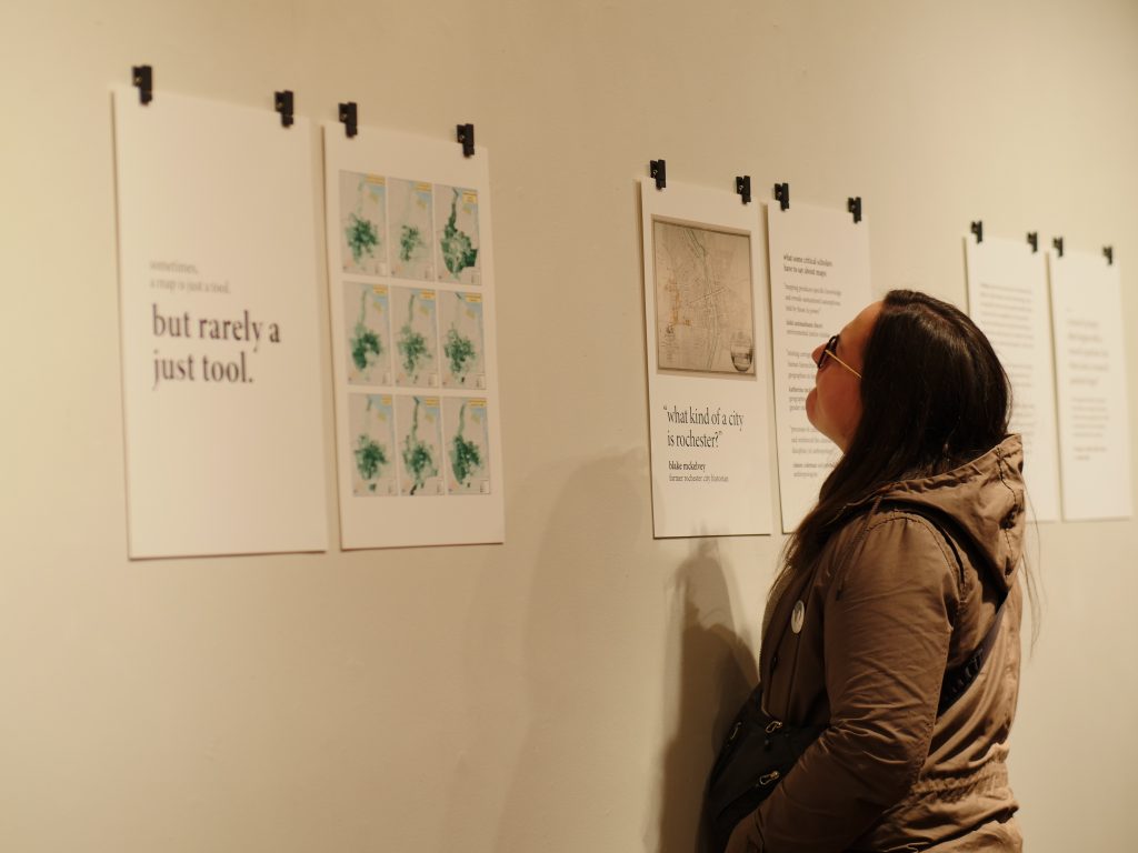 a gallery visitor examines one of the zine prints