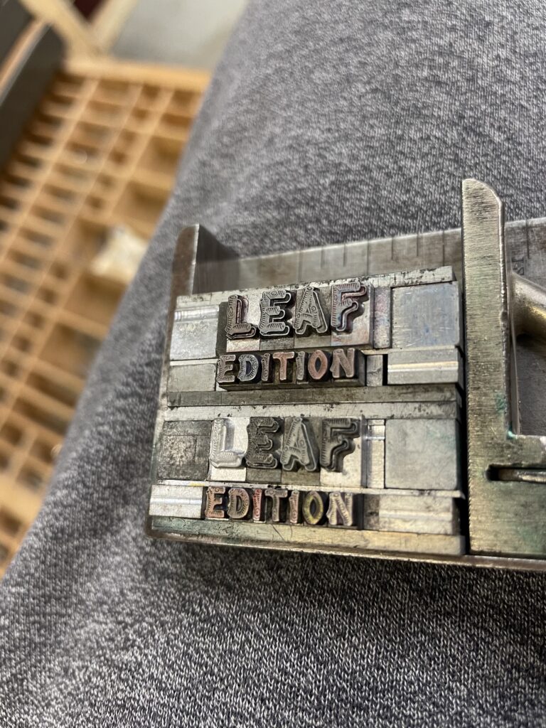 a reversed photo of metal letterpress type arranged to spell "leaf edition"